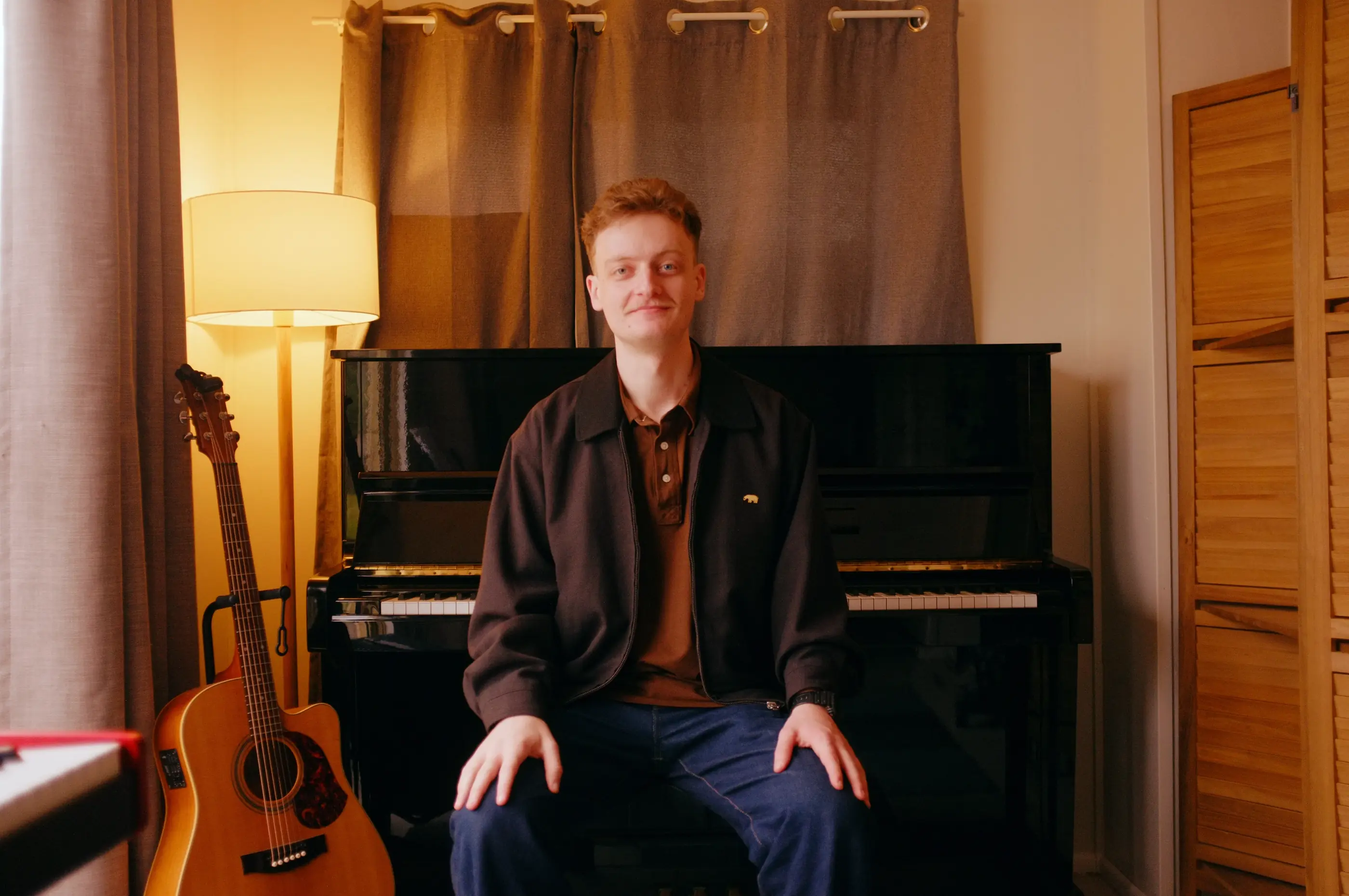 Reuben Rees seated in his Rochedale South piano studio